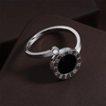 Macro shot of silver titanium ring featuring a Roman numeral disk and zircon detail - Black Shell Silver
