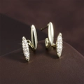 Macro shot of curved gold-plated earrings with pavé set cubic zirconia and polished surface - Double Row Curve Micro Pave Style (EP6018-Gold)