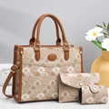 Detailed view of 3-piece bag set including tote and clutch in textured fan pattern - Khaki