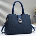 Detailed texture of navy blue floral lace with elegant gold teardrop metal buckle - Blue
