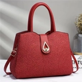 Detail of red floral lace pattern on tote bag with a golden teardrop twist lock clasp - Red
