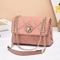 Pink quilted crossbody chain bag with golden floral clasp and faux leather texture - Pink