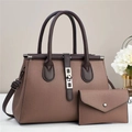 Detail of lychee textured leather tote set with contrasting handles and metal lock - Coffee