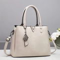 Elegant beige faux leather handbag with V-shaped metal logo and adjustable shoulder strap - White