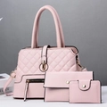Detailed view of pink three-piece handbag set featuring lattice embossed texture and gold hardware - Pink