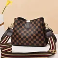 Detail of checkered crossbody bucket bag with wide striped nylon strap and metal buckle - Coffee Checkerboard/Coffee