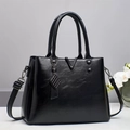 Classic black leather-textured handbag with V-shaped metal hardware and charm - Black