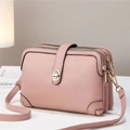 Detailed view of pink lychee grain crossbody bag with three zippers and gold buckle - Pink