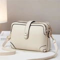 Close-up of beige lychee textured leather crossbody bag with three zipper compartments - Off-white