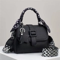 Detail of black lychee grain handbag with polka dot scarf handle and star charm - Black