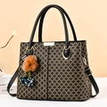 Brown checkerboard tote bag with dual handles and colorful plush pompom charms - Black