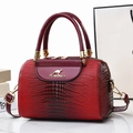 Deep red crocodile embossed bucket bag with kangaroo logo and gold hardware accents - Burgundy