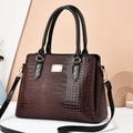 Deep reddish brown lizard texture tote bag with black handles and gold hardware accents - Coffee