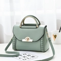 Borsa a mano trapezoidale verde salvia con lati in pelle intrecciata e chiusura oro - verde chiaro