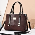 Elegant burgundy crocodile pattern handbag with gold hardware and black top handle - Coffee