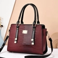 Deep red lizard-textured shoulder bag with gold hardware and stylish black handles - Wine Red