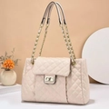 Elegant beige quilted crossbody bag with gold chain strap and turn-lock on a clean desk - Beige