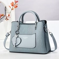 Detail of light blue pleated handbag with metallic heart charm and fashion lettering - Blue