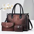 Detailed view of 3-piece dark brown faux crocodile embossed tote, clutch, and card holder set - Khaki/Earth Yellow