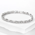 Detail of silver-tone X-shaped bracelet with cubic zirconia on white stone stand - Silver