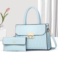 Macro shot of light blue textured leather tote with gold metal buckle and matching wallet - Blue