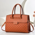 Close-up of caramel brown handbag featuring woven checkerboard texture and gold-framed hardware - Khaki/Earth Yellow