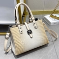 Detail of cream striped shoulder bag with silver flower buckle and crocodile texture - White