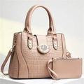 Detail of beige crocodile embossed tote bag set with star buckle on marble podium - Khaki