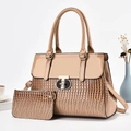 Detailed macro of lizard-patterned handbag with round metal buckle and mini pouch accessory - Khaki