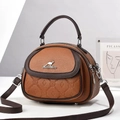 Detail of lychee pattern leather handbag with kangaroo silver logo and shell shape design - Earthy Yellow
