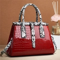 Elegant red crocodile textured tote bag with snakeskin pattern handles and shoulder strap - Red