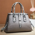 Detail view of grey faux crocodile skin handbag with stylish snakeskin pattern accents - Dark Gray