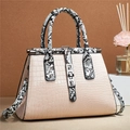 Detail of stone-patterned handbag featuring snake-print handles and silver twist lock - Khaki