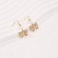 Elegant gold bow earrings with white pearl and sparkling crystals on white backdrop - Gold