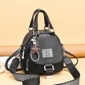 Black pebbled leather bag with metal S logo and decorative star charm on shoulder strap - Black