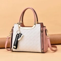 Pink and white woven tote bag with adjustable shoulder strap and decorative charms - Pink