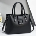 Minimalist black pebbled leather tote bag with stylish metal buckles and shoulder strap - Black