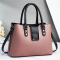 Detail of pink and black leather tote bag with lychee texture and square buckle - Pink