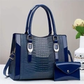 Close-up of navy blue lizard texture handbag set with matching envelope clutch and gold hardware - Blue Gold