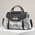 Contrast leather handbag with floral pattern, swan metal clasp and pearl details - Black
