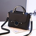 Minimalist black pebbled leather crossbody bag with round gold handle and metal buckle - Black