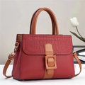 Close-up of contrast leather texture and crocodile embossed flap on tote bag - Red