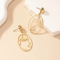 Minimalist gold hollow face earrings with abstract outline design on a stone display - Abstract Face Earrings / Gold