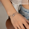 Close-up of minimalist silver open cuff bracelet with dual metal beads on female model - Silver (S006)