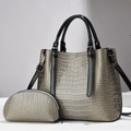 Detail of gray crocodile pattern tote bag set with glossy finish and tassel accents - Gray