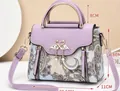 Purple paisley pattern leather handbag with golden swan buckle and pearl tassel details - Purple
