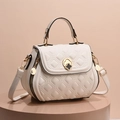 Quilted cream shell shoulder bag with gold clover lock and adjustable strap - White