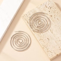 Modern silver spiral hoop earrings with minimalist geometric design on marble surface - Silver