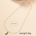 Détail du collier chaîne dorée 45+7cm avec pendentif note de musique en émail noir - Croche (X81-Note)