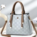 Detail of checkered embossed texture and brown decorative buckle on dual-tone handbag - Mint Green